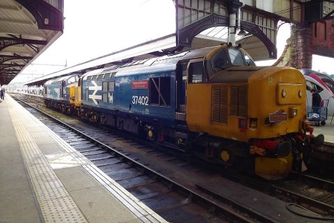 Two class 37 locomotives stand in Norwich station