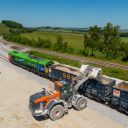 Overhead shot of a mechanical shovel (a digger) loading an aggregate train at Hillhead, a countryside location in Derbyshire