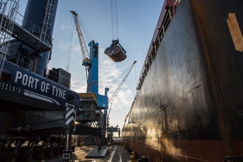 Image shot from the quayside as bulk load is transferred from a ship at Port of Tyne