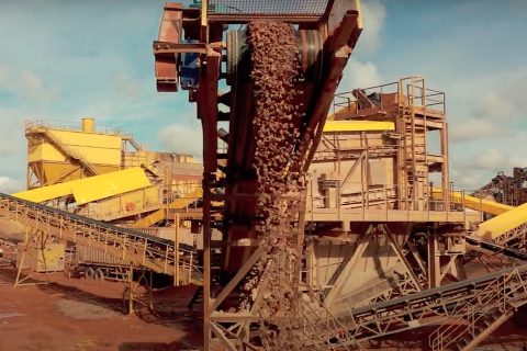 Quarry conveyor flow of granite chips seen from head on