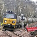 Heavy tanker train leans into curve leaving Perth