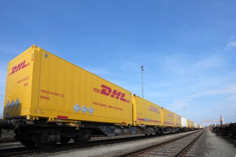 DHL container train against a blue sky