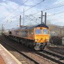 A class 66 diesel locomotive hauls a tanker train through Slateford station in Edinburgh