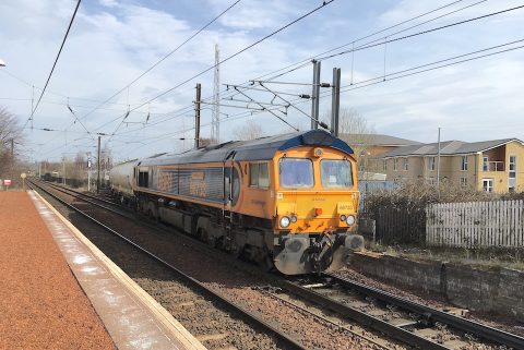 A class 66 diesel locomotive hauls a tanker train through Slateford station in Edinburgh