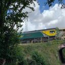 Freightliner aggregates train passes a wooded section of line near Dronfield