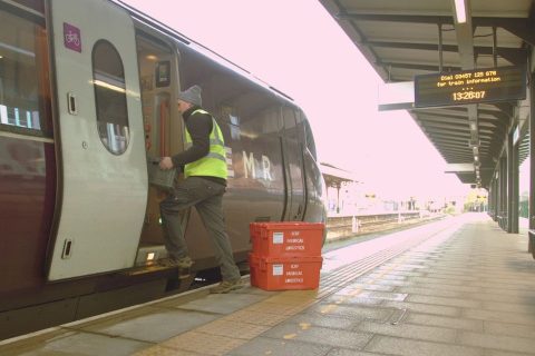 InterCity RailFreight operative loading supplies onto an EMR train