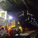 Engineers at work in the nighttime on the installation of electrification equipment