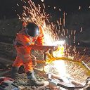 Welder at work on the railway with sparks flying