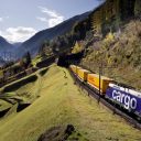 DHL Global rail train on a forested hillside