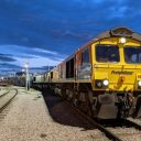 seen from infant of the first locomotive a double headed Freightliner Intermodal service under a very blue sky