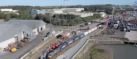 from the air - a container train leaves teh port of Waterford with the Irish countryside in the background