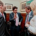 Four businessmen and one business woman standing talking, in the centre is the UK Rail Minister Huw Merriman and the CEO of GB Railfreight, John Smith