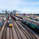 Aerial view of freight trains at Felixstowe with cranes in background