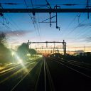 Dawn over railway tracks with engineering floodlights