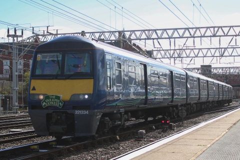 Electric multiple unit glinting in the sunshine with train nameplate The Varamis Express