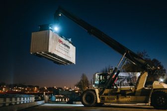 Night time shot of reach stakes moving XPO liveried container